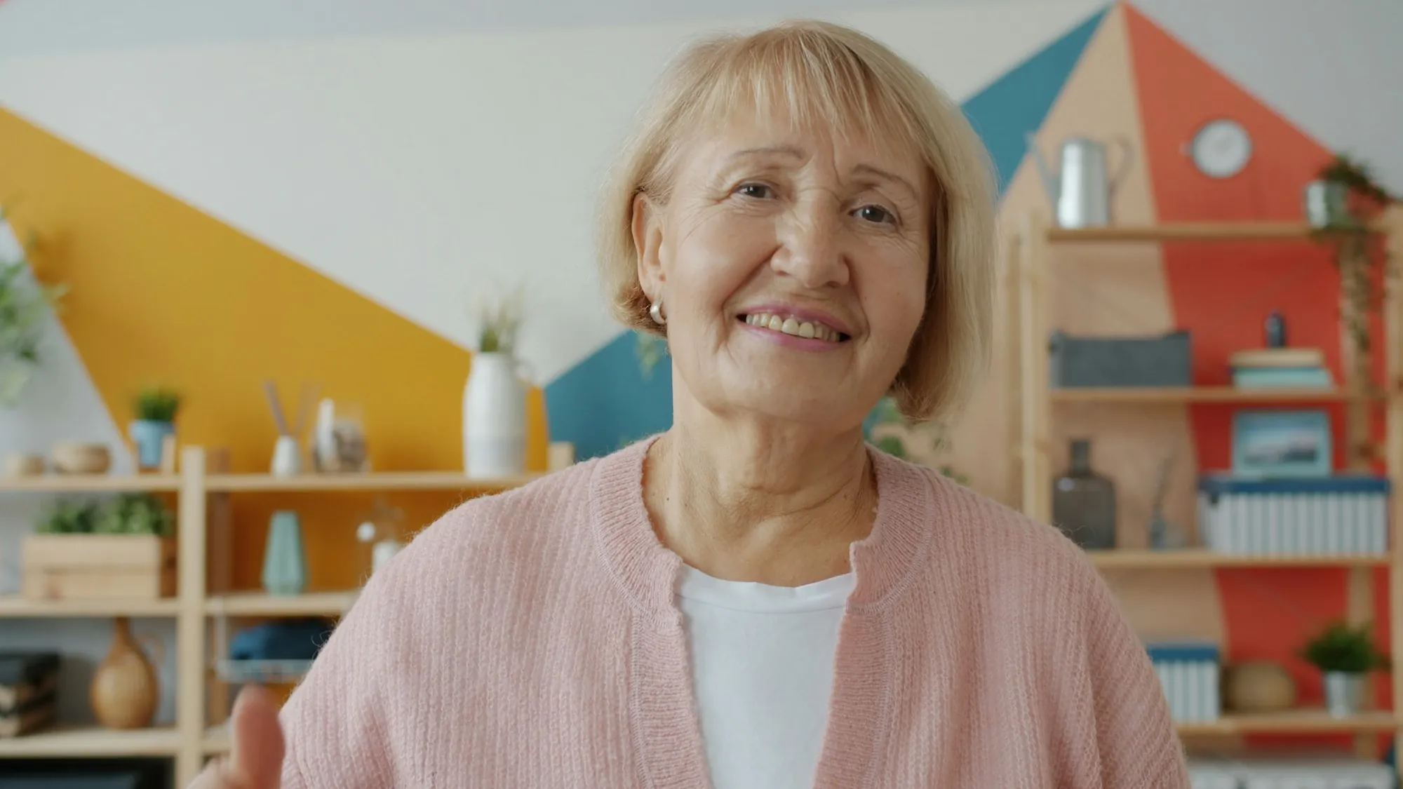 An older woman sitting at a kitchen table in the morning