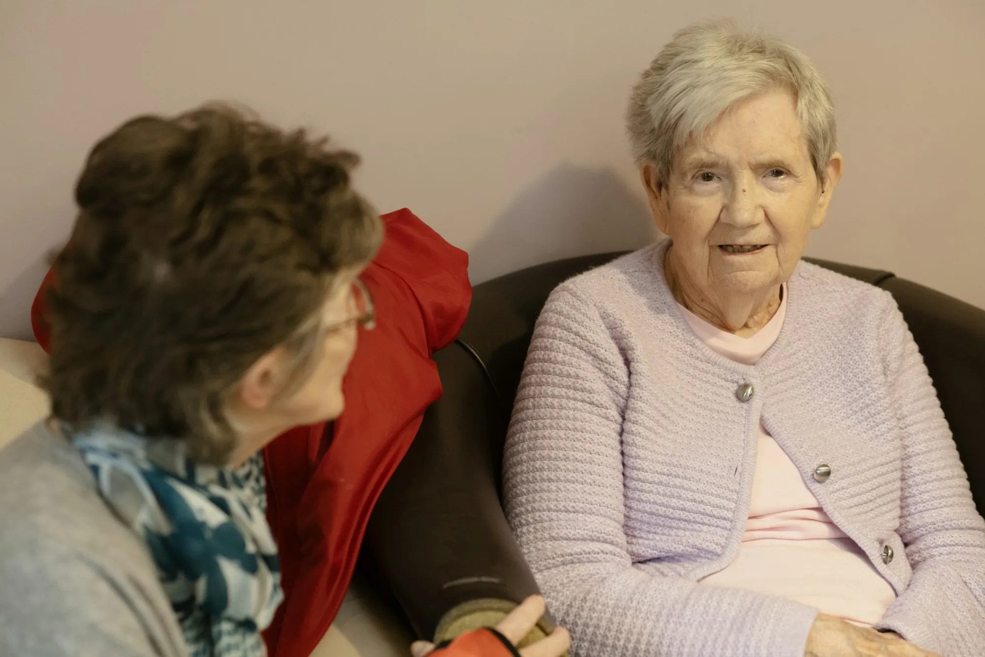Two older women sitting and talking