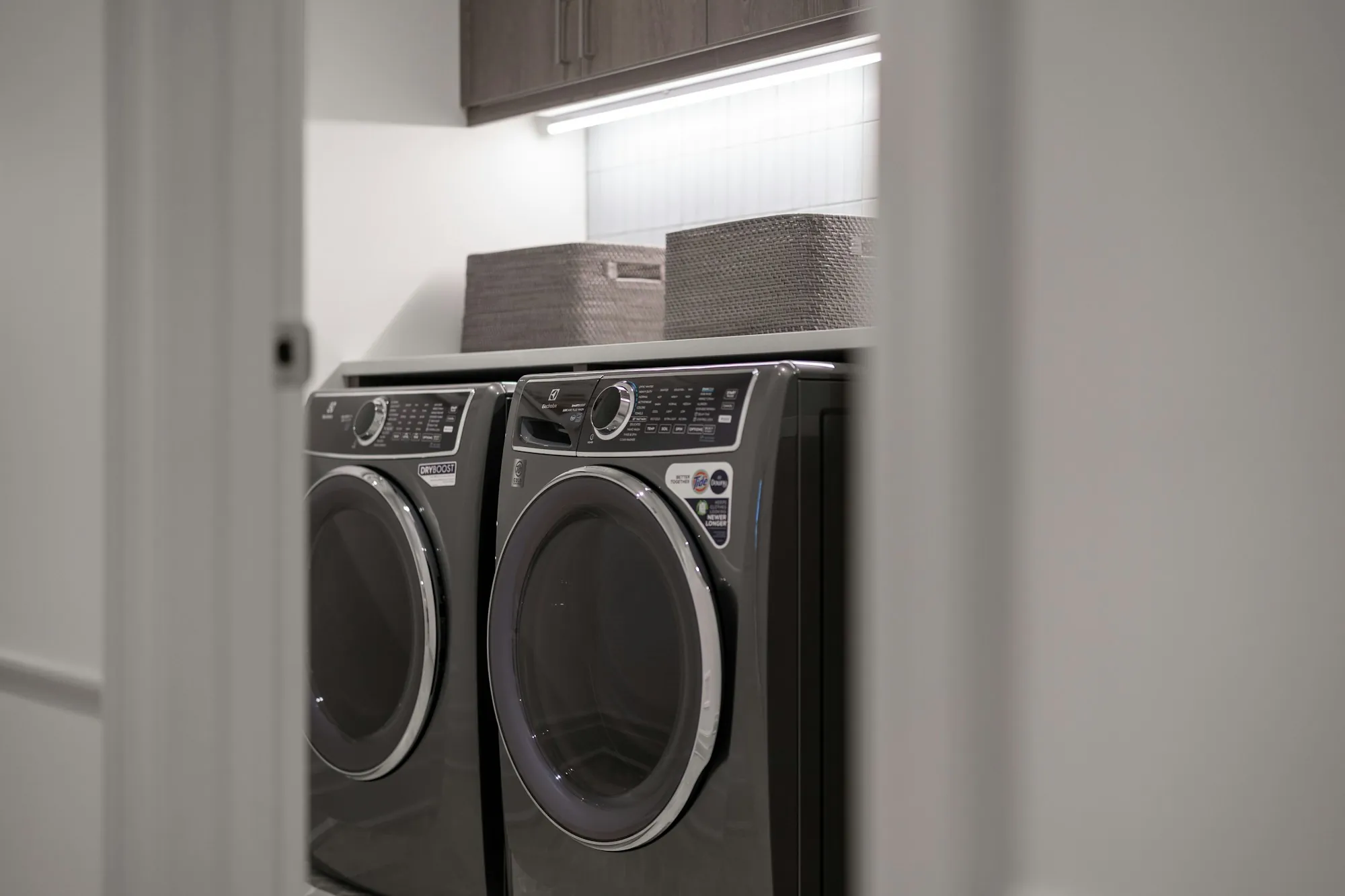 A tidy utility room with a washing machine